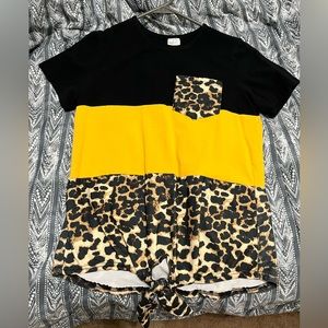 This yellow and black cheetah shirt size small.